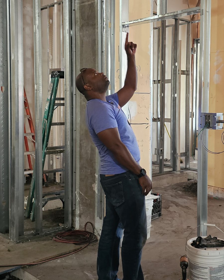Matthias Williams on a jobsite, checking framing